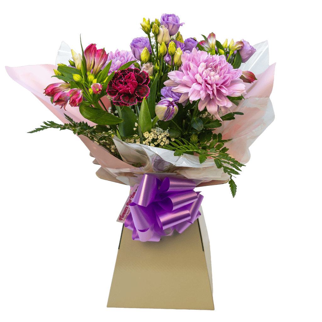 Purple and pink flower arrangement in a presentation box with a bow for local delivery.